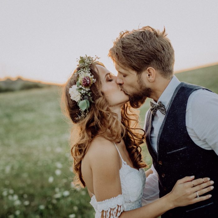 beautiful-bride-and-groom-at-sunset-in-green-natur-PM8YVNS.jpg